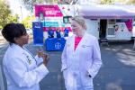 Janine Bera (left), chief medical officer for WellSpace Health, talks to Elizabeth Morris (right)