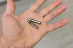 Open hand shows dual chamber leadless pacemaker, made up of two silver cylinders that look like “AA” batteries