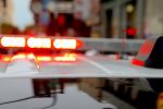 Red and blue lights on the top of a law enforcement vehicle in a city