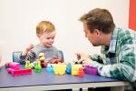 Father with son playing with blocks and Playskool figures