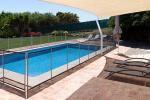 A backyard swimming pool shown here surrounded by a fence to prevent small children from entering
