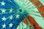 Portion of an American flag behind glass with a bullet hole