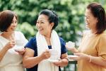 Senior female friends drinking tea outside