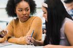 Two teen girls studying together