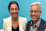 Gita Fulwiler and Frank Ing sitting on patient bed together in clinic.