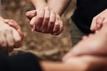 Cropped shot of a group of unrecognizable people holding hands out in nature