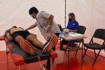 Health care worker performs heart screening on patient