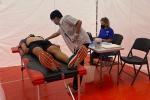 Person receives EKG in medical tent