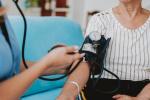 Home care healthcare professional measuring blood pressure