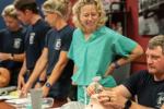 Nurse anesthetist helps firefighters learn how to insert airway device on a mannequin. 