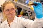 Lab researcher holding a vile