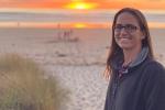 Leslie Peek alone with beach in background