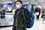 Man in airport wearing a mask