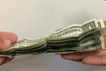 One person puts money into another person's hand