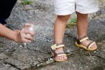 Child being sprayed with repellent