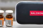 Two brown vials of naloxone and black case that says Naloxone