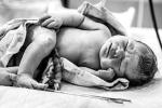 newborn baby with freshly cut cord 