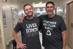 Two people in a hospital hallway wearing matching gray shirts, one labeled “Liver Donor” and the other “Contains Recycled Parts.”
