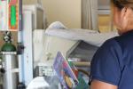 Picture of nurse in NICU with book