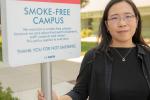 Elisa Tong standing next to no smoking sign