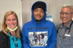 A woman, man and teenager in a hospital hallway