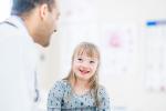 Patient with Down Syndrome speaking with doctor