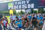 People begin running the race at the start line.