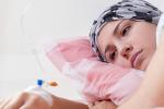 Photo of young pretty cancer girl lying in hospital