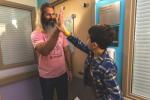 Child and adult giving a high five  outside the playroom