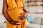 Pregnant black woman in an orange dress