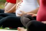 Pregnant women, group of moms during pregnancy attending prenatal lesson in city park. The girls massage their belly.