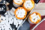 Top view of full prescription bottles with stethoscope and pills on rustic wooden United States background