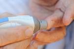 Person pricking their finger 