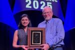 Female and male holding plaque award for neuroscience 2025