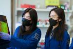 Professor Lin Tian working in her lab with graduate students