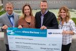 Lor Randall, dealership owners Bryant and Kirsten McCarver, and nurse practitioner Abby Inkster accept check from Shingle Springs Subaru