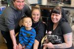 Family of four with three showing their tattoos