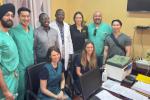 Group of doctors standing together behind a desk.