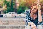 Unhappy thoughtful girl with cigarette