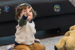 Toddler reaching for bubbles