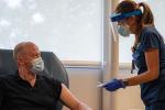 A female nurse is preparing a male participant to take part in the vaccine clinical trial