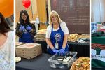 Left: A woman with long, dark brown hair smiles widely next to a young girl whose face has been painted with red and green stripes and a heart. Center: Two women wearing blue aprons stand between two long black tables filled with cardboard pizza boxes, croissant sandwiches, a crate of oranges and condiments. Right: A woman wearing a black T-shirt sits in front of a large wooden pillar and behind a table with a green tablecloth.