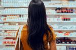 Woman looks at pharmacy shelf.