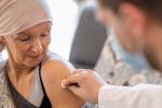 Adult woman receiving vaccine from doctor