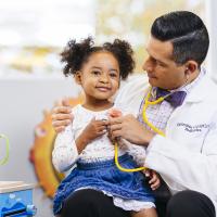 Child sitting on a doctors lap