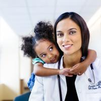 Child hugging a doctor