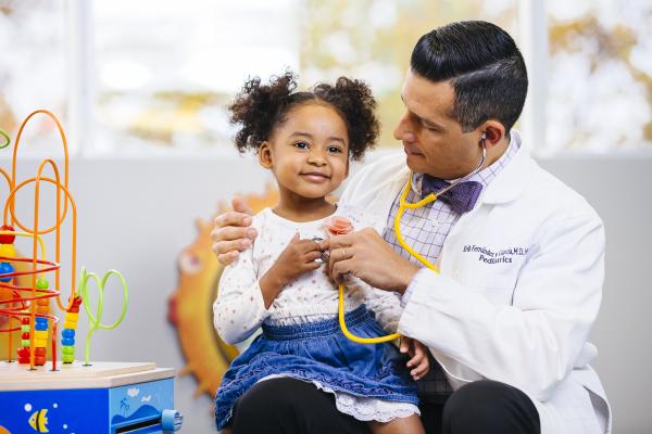 Child sitting on a doctors lap