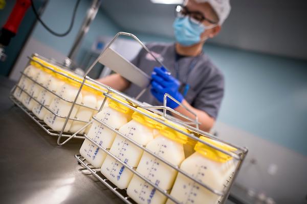 UC Health Milk Bank staff member works with containers of donated human milk