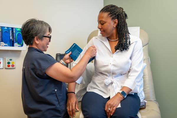 health care professional putting a blood pressure cuff on a patient
