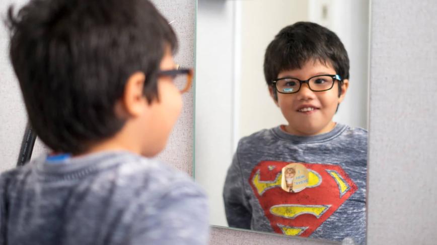 Child looking in mirror